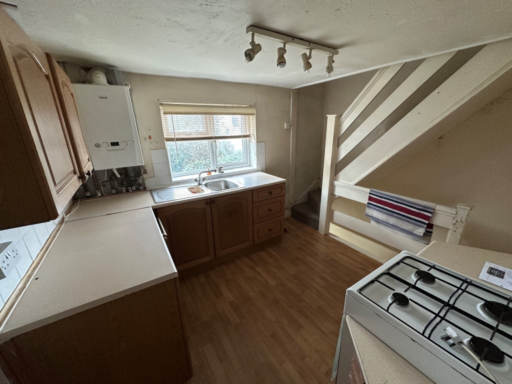 Lot: 170 - TWO-BEDROOM TERRACE HOUSE FOR REFURBISHMENT - Kitchen with Staircase up and down